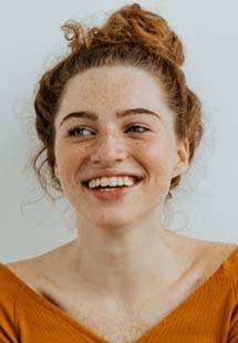 Smiling woman with red hair after Invisalign orthodontics in Weymouth